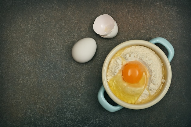 Baking ingredients eggs and flour on table