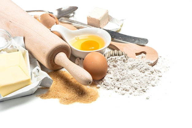 Baking ingredients flour eggs Wooden kitchen utensils Food background