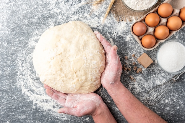 Baking ingredients with pressed yeast, eggs, sugar, milk, and flour