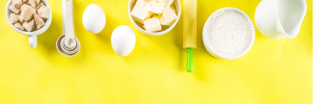 Baking ingredients on yellow background