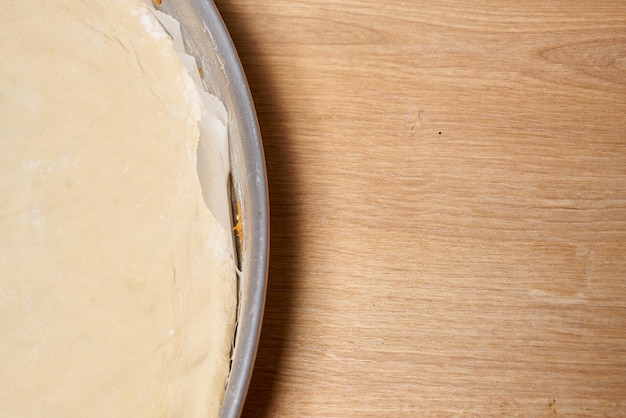 A baking pan with a pizza crust on it.