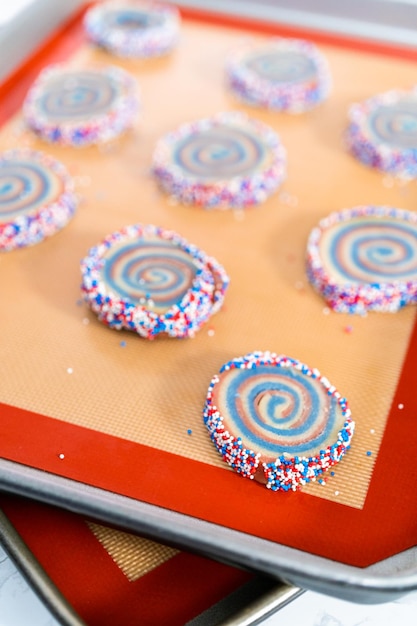 Baking red, white, and blue pinwheel sugar cookies for july 4th celebration