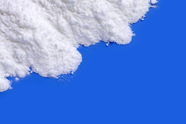 Baking soda on blue background.