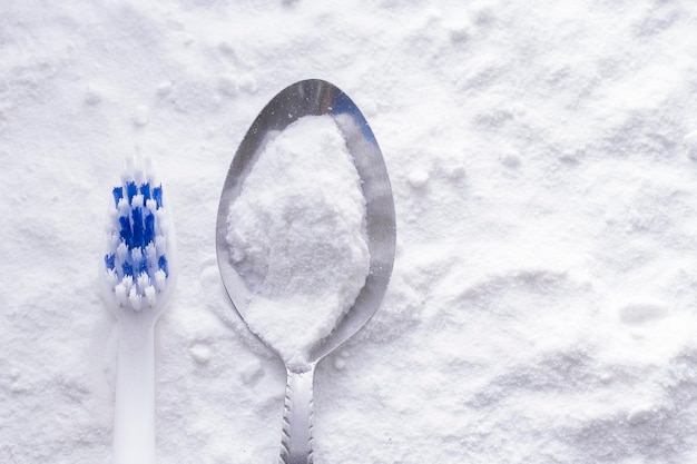 Baking soda and brush are the wooden table