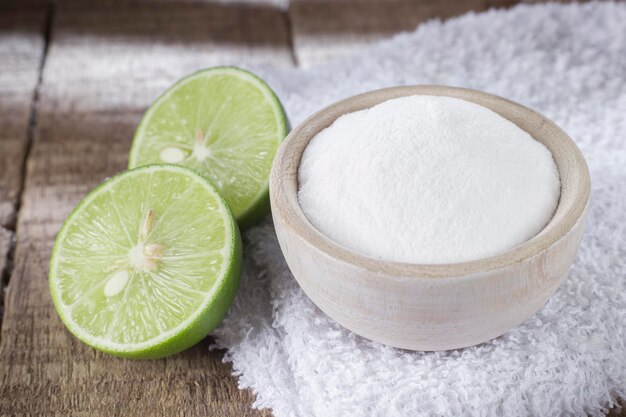 Baking soda and lemon on wooden table