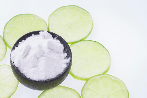 Baking soda and slices of lemon on white background