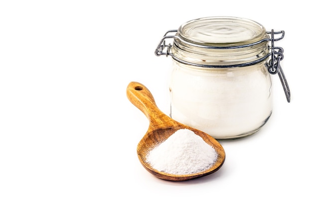 Baking soda in a wooden spoon, isolated