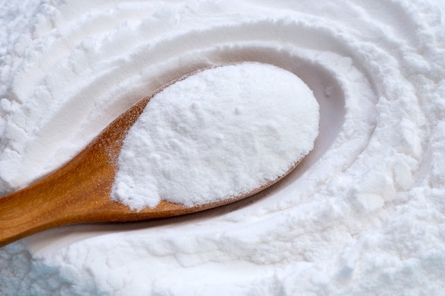 Baking soda in wooden spoon