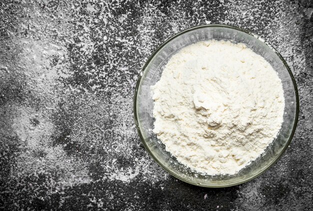 Baking table. Bowl of flour on a rustic table.