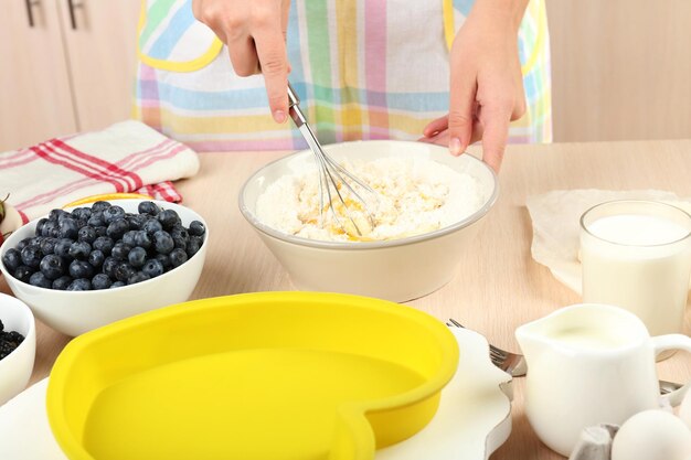 Baking tasty pie and ingredients for it on table in kitchen