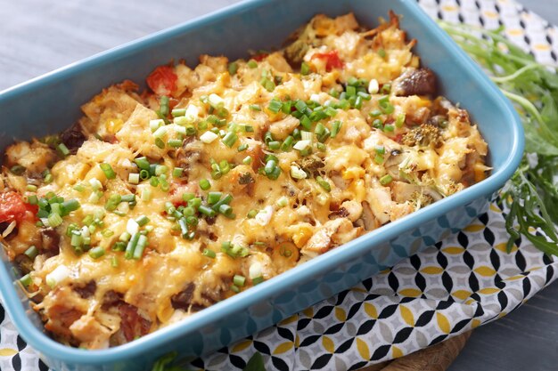 Baking tray with delicious turkey casserole on table closeup