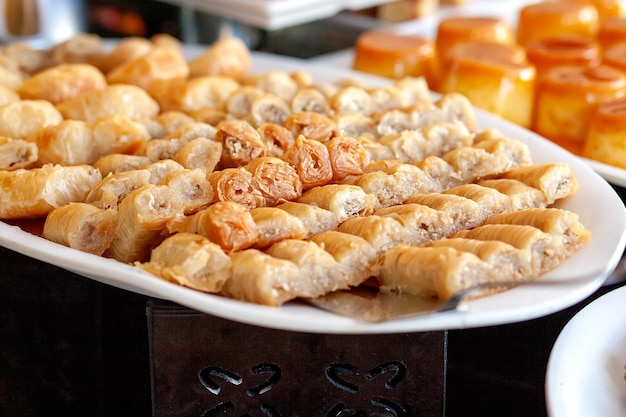 Baklava is a layered pastry dessert made of filo pastry filled with chopped nuts and sweetened with syrup or honey Dessert table in a Turkish hotel