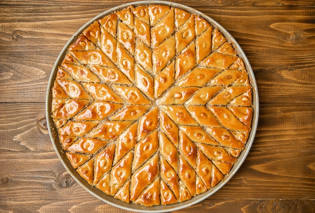 Baklava with nuts on a wooden background. Selective focus.