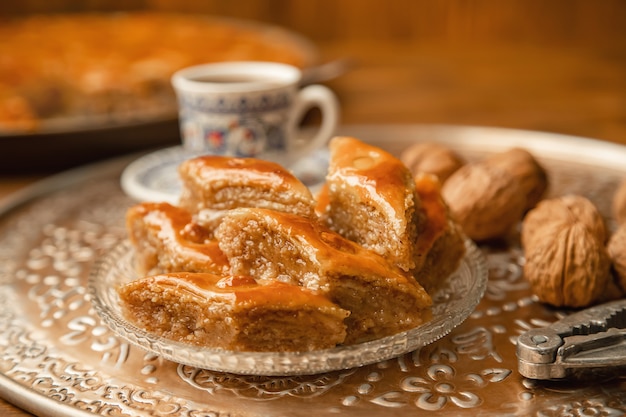 Baklava with nuts on a wooden background. Selective focus.