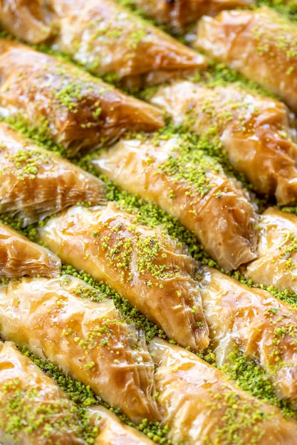 Photo baklava with pistachio in a tray aegean cuisine delicacies local name sobiyet baklava close up