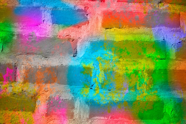 Bakstenen muur met veelkleurige verf close-up. Achtergrondbaksteen creatief.