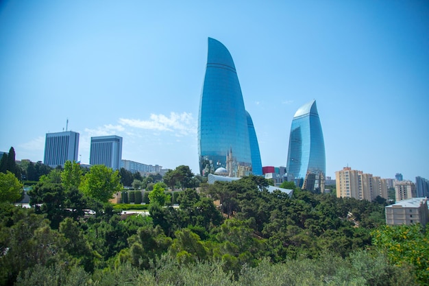 БАКУ, АЗЕРБАЙДЖАН, 15 ИЮЛЯ 2018 г. Вид на Flame Towers с набережной возле Milli Park Flame Towers самое высокое здание в Азербайджане, расположенное в Баку