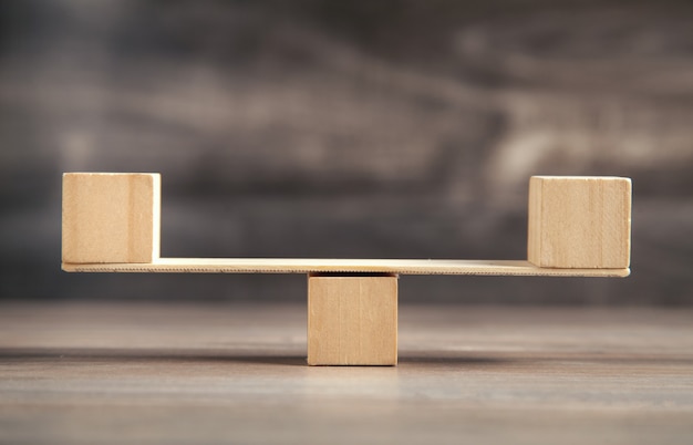 Photo balance scales made in from wooden cubes.