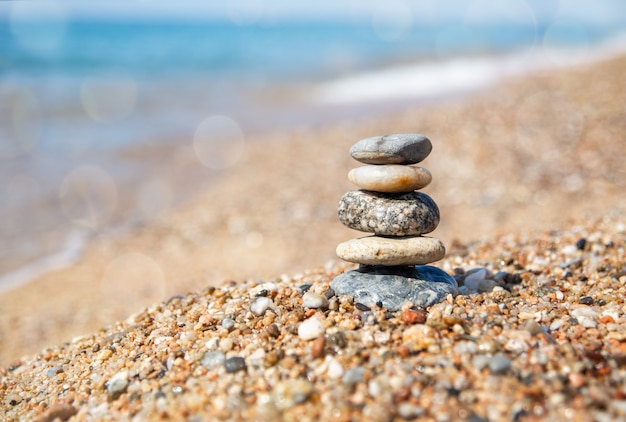 Balance of stones on the beach, sunny day