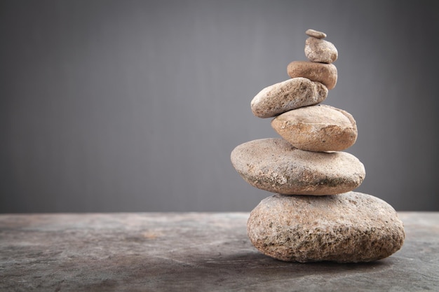 Balance stones on grey background