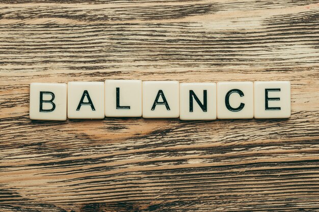 Balance with wooden cubes on background