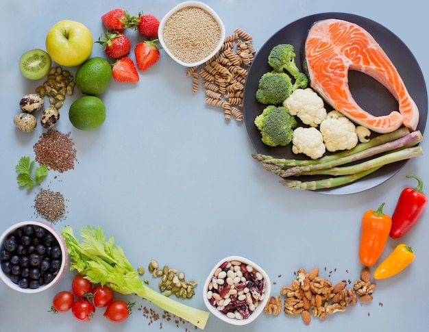 Balanced diet food frame background fresh vegatables fruits\
cereals seeds and nuts