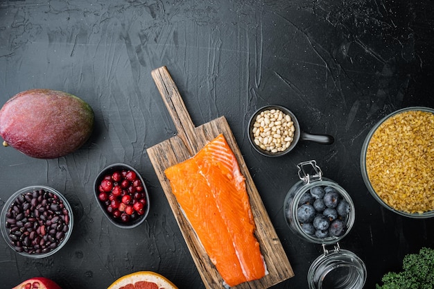 Balanced diet organic healthy food clean eating selection, flat lay with space for text, on black background