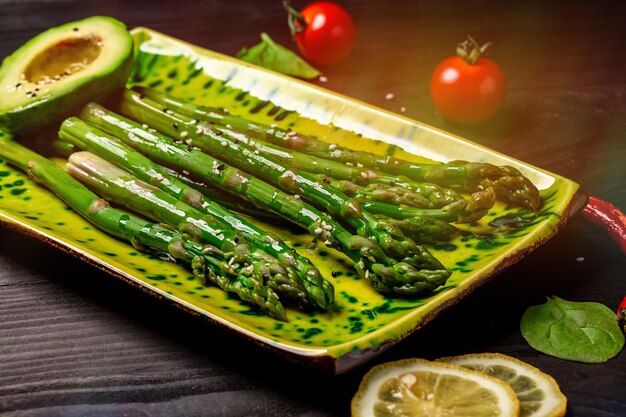 Balanced healthy food grilled avocado with asparagus and green salad vegan food