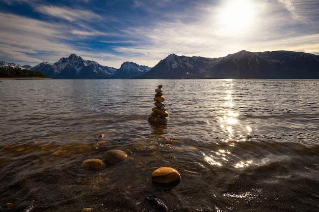 Balanced rock pyramid at the jackson lake at sunset wyoming usa