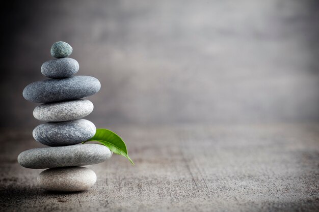 Balancing stones on the grey background.