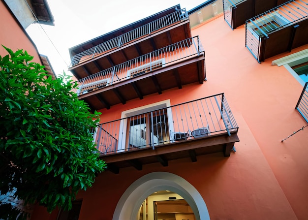 Balconies of Colorful Modern residential apartment and flat building exterior near Garda lake of Trentino of Italy. New luxury house and home complex. City Real estate property and condo architecture.