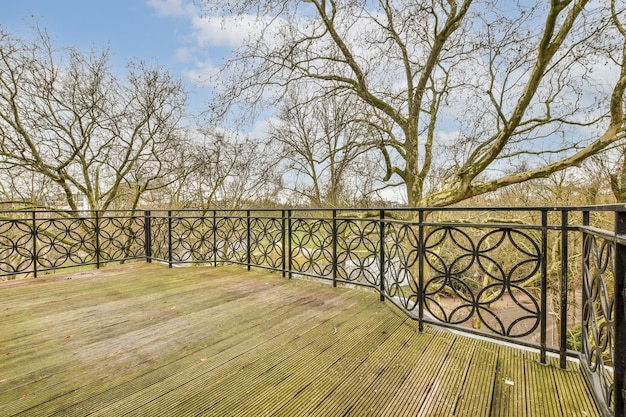 The balcony has a view of the river and trees