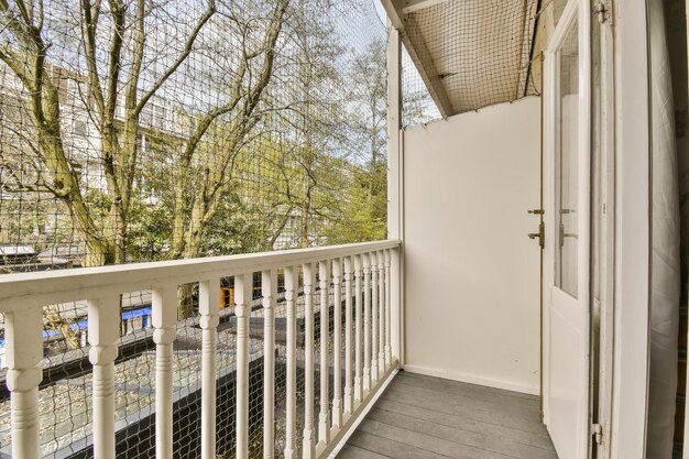 The balcony has a view of the street and trees