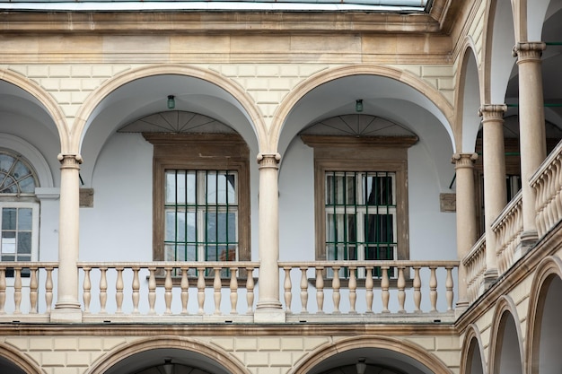 A balcony with a balcony and a balcony with a green fence.