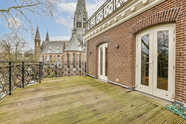 A balcony with a brick building and a large castle