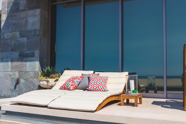 a balcony with a couch and pillows on it