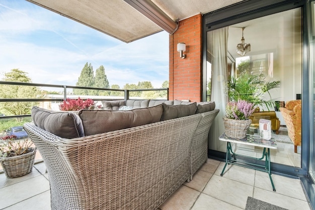 Balcony with a large wicker gray armchair