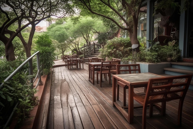 A balcony with tables and chairs and trees in the background