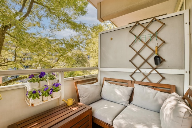 a balcony with two couches and a wooden table