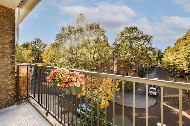 A balcony with a view of a street and trees