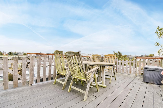 Balcony with wooden chairs and table