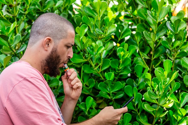 Bald and bearded man smoking