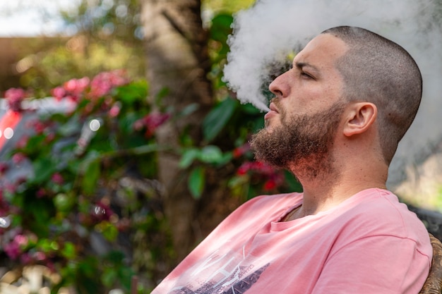 Bald and bearded man smoking