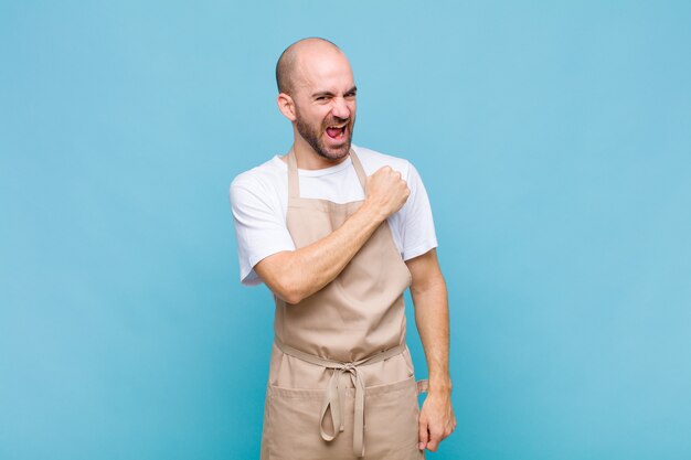 Bald man feeling happy, positive and successful, motivated when facing a challenge or celebrating good results