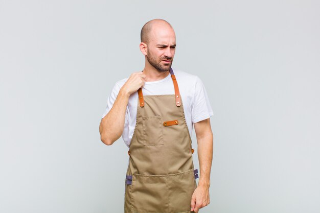 Bald man feeling stressed, anxious, tired and frustrated, pulling shirt neck, looking frustrated with problem