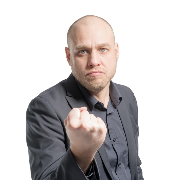 Bald man in a gray suit threatens fist isolated