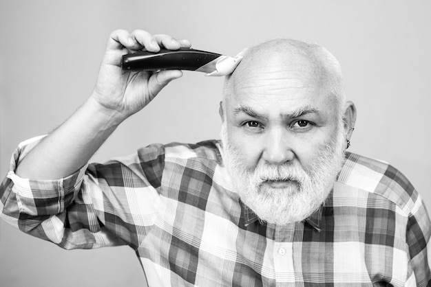 Bald man hairclipper mature baldness and hair loss concept middle aged gray man