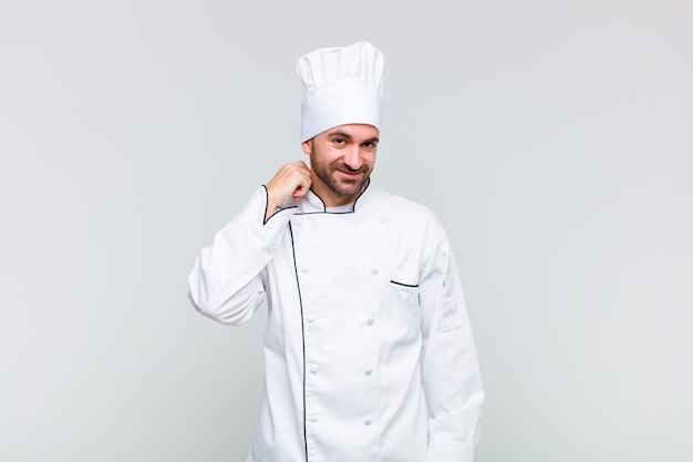 Bald man laughing cheerfully and confidently with a casual, happy, friendly smile