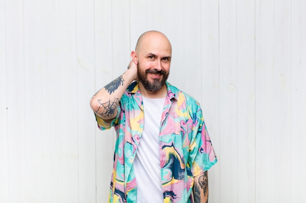 Bald man laughing cheerfully and confidently with a casual, happy, friendly smile