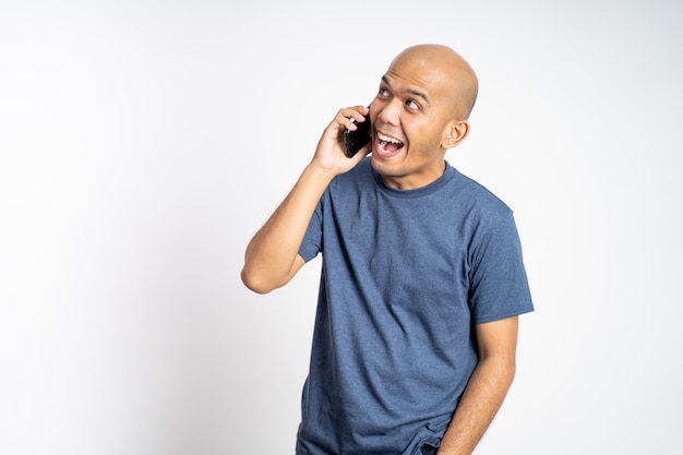 Bald man laughing while making phone call